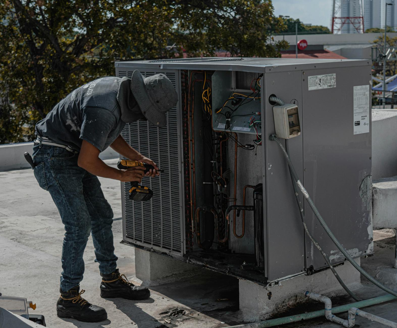 A Stone Ridge Roofing crew member inspecting a roof for storm damage on a residential home in Wakefield, Massachusetts, with a clear focus on safety and precision.