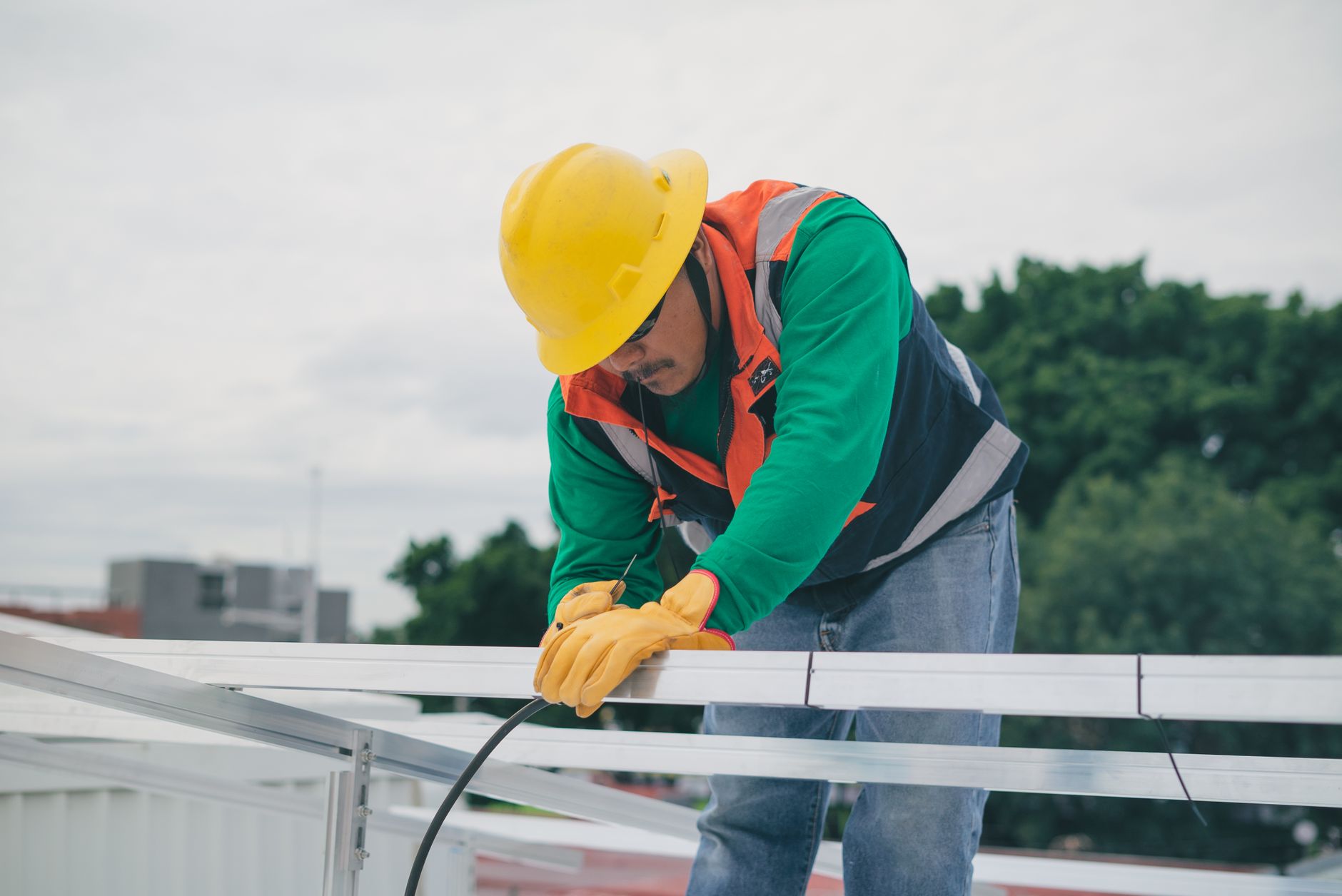A professional roofer conducting a detailed roof inspection on a historic home in Beverly, Massachusetts, with attention to coastal roofing challenges.