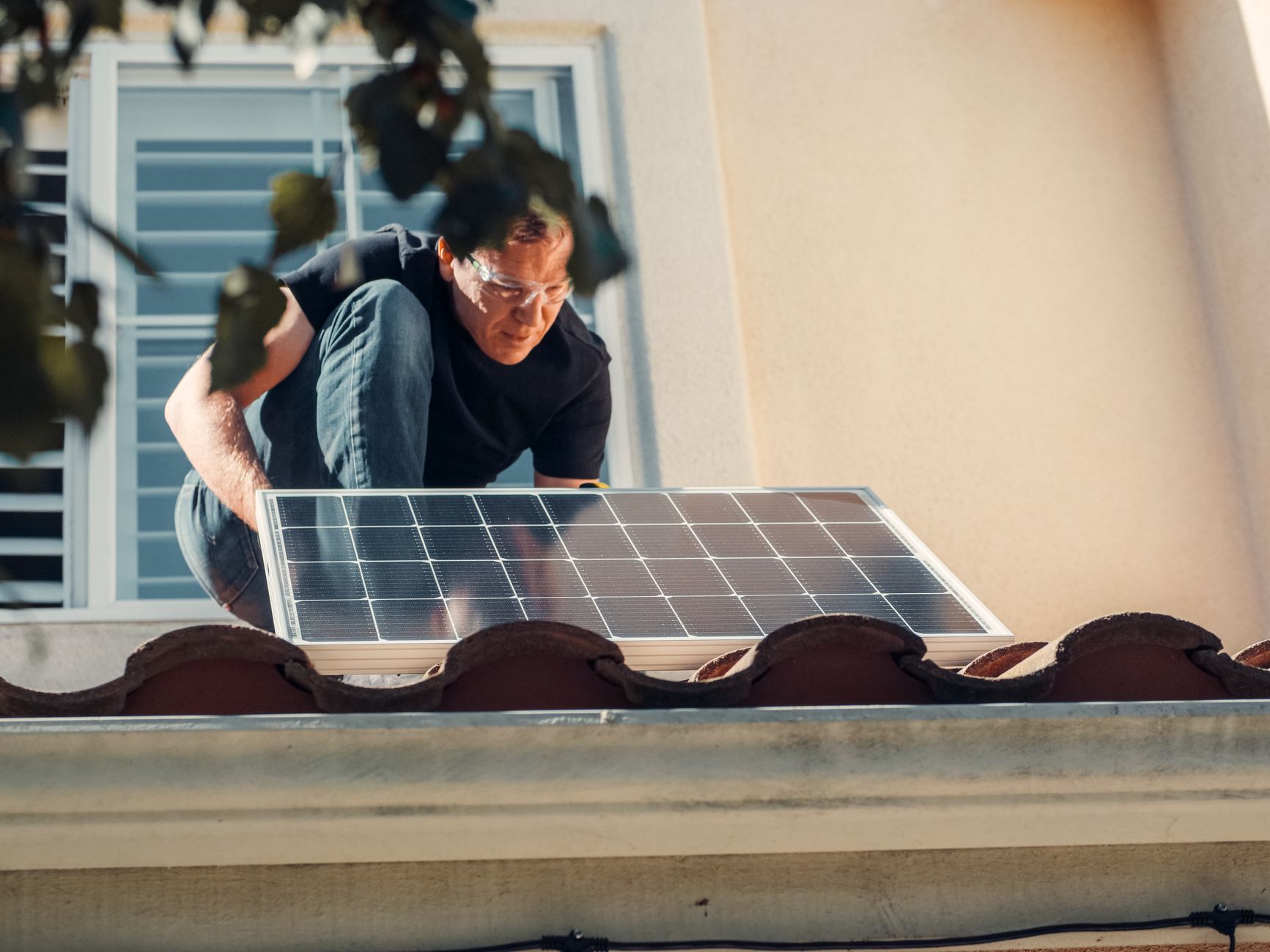 Roofing contractor inspecting a residential roof in Saugus, Massachusetts, with a focus on proper attic ventilation and shingle condition.