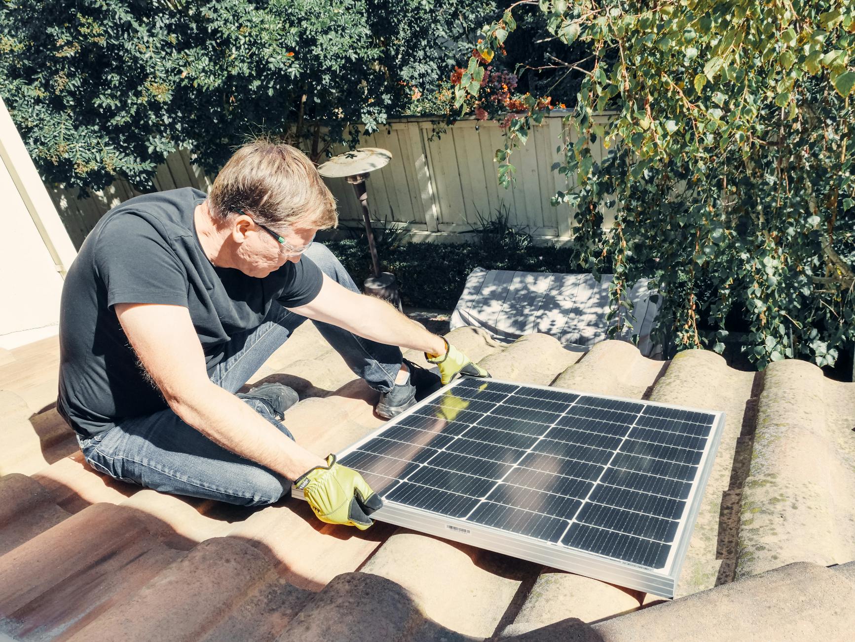 A Stone Ridge Roofing technician performing a detailed roof inspection on a historic Salem home, carefully checking shingles and flashing.